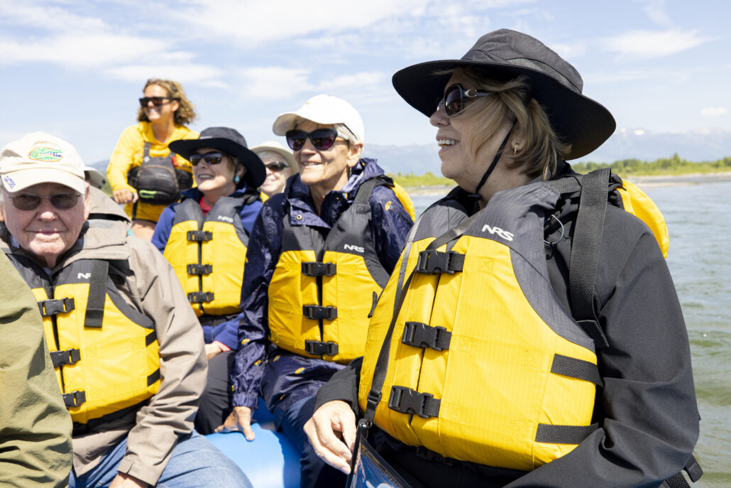 An elderly group enjoying a scenic raft experience on the Snake River.
